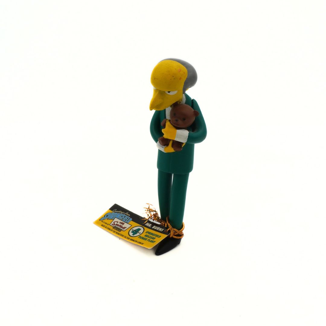 Figurine of a character from 'The Simpsons' holding a baby, with a white background