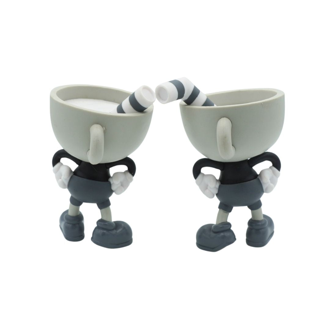 Photo of the back of Cuphead and Mugman figurines in greyscale, photographed against a white background
