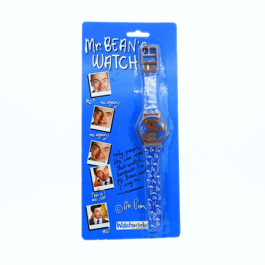 A Mr. Bean themed watch in its original blue blister packaging, featuring a clear strap with white patterns and a blue watch face.