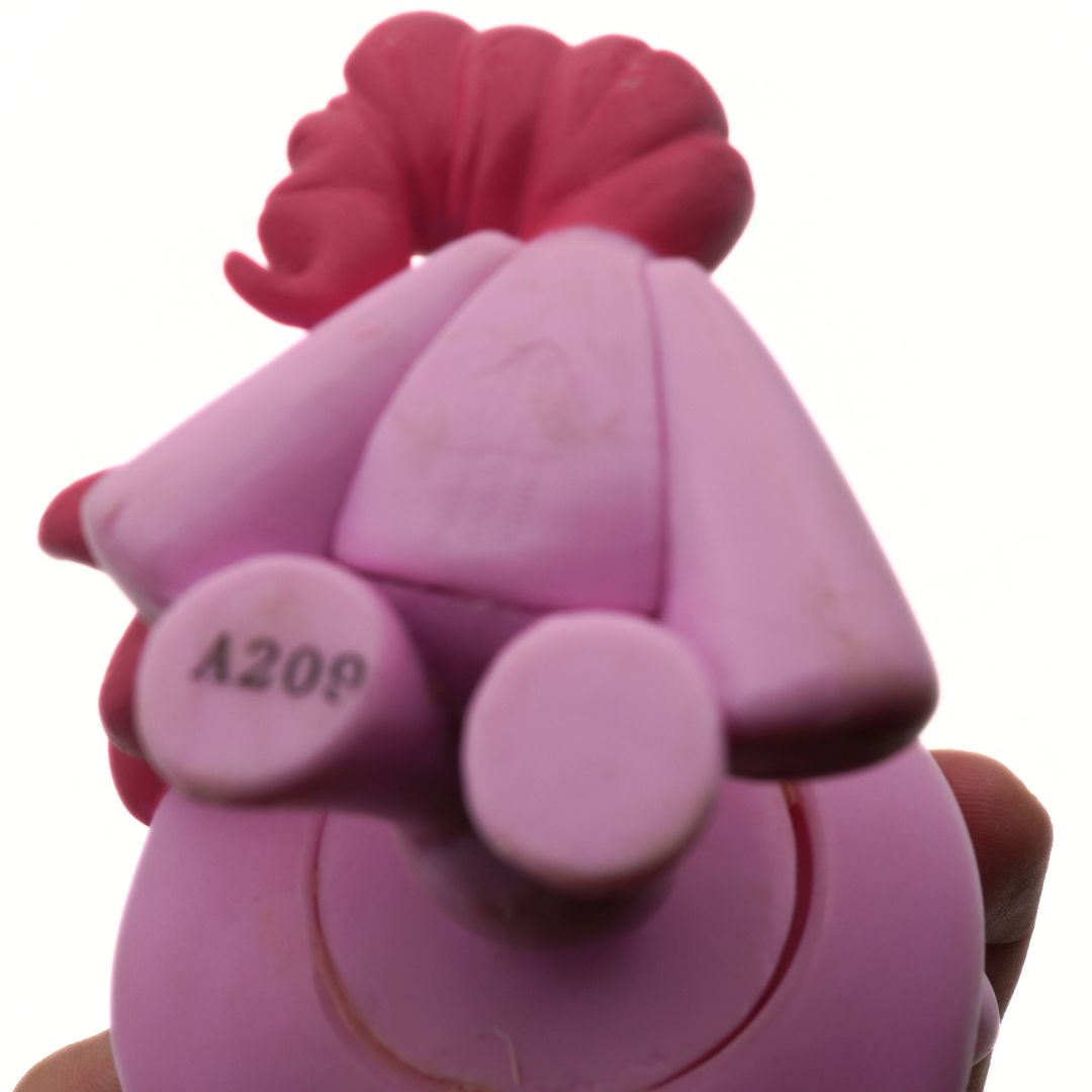 Pink toy figure with a hat on a white background