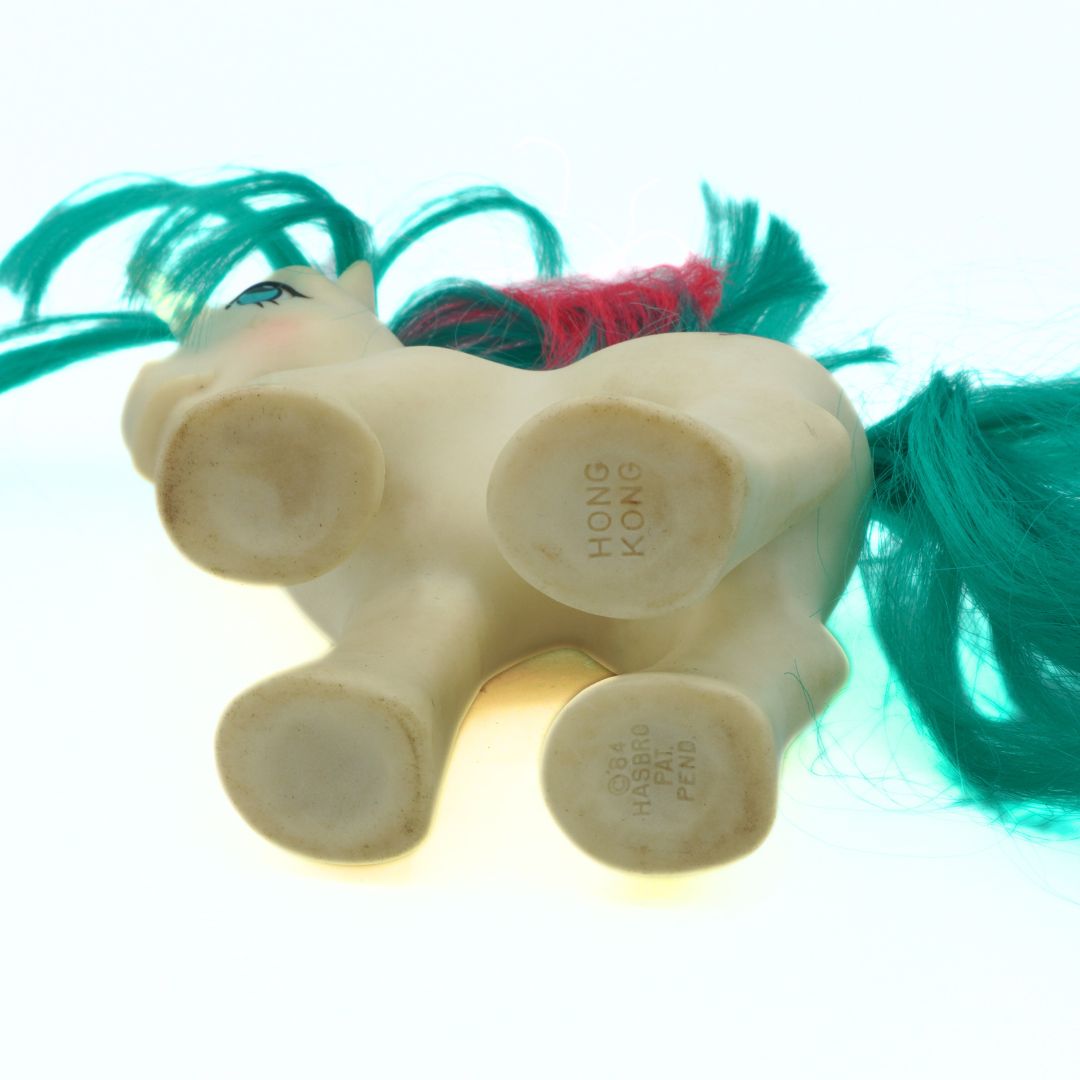 Toy horse with green hair on a white background