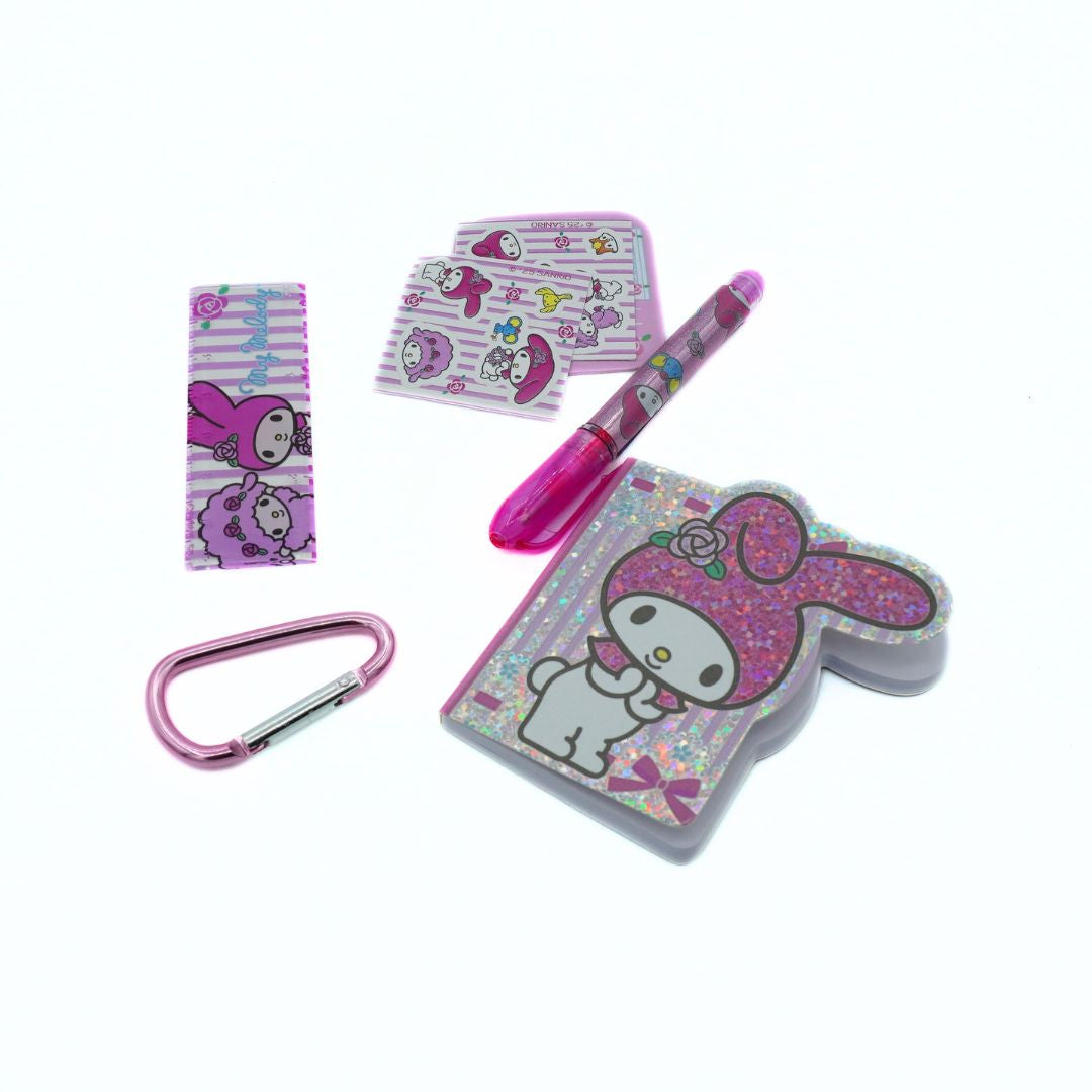 Pink glittery notebook, pen, carabiner, ruler and stickers on a white background