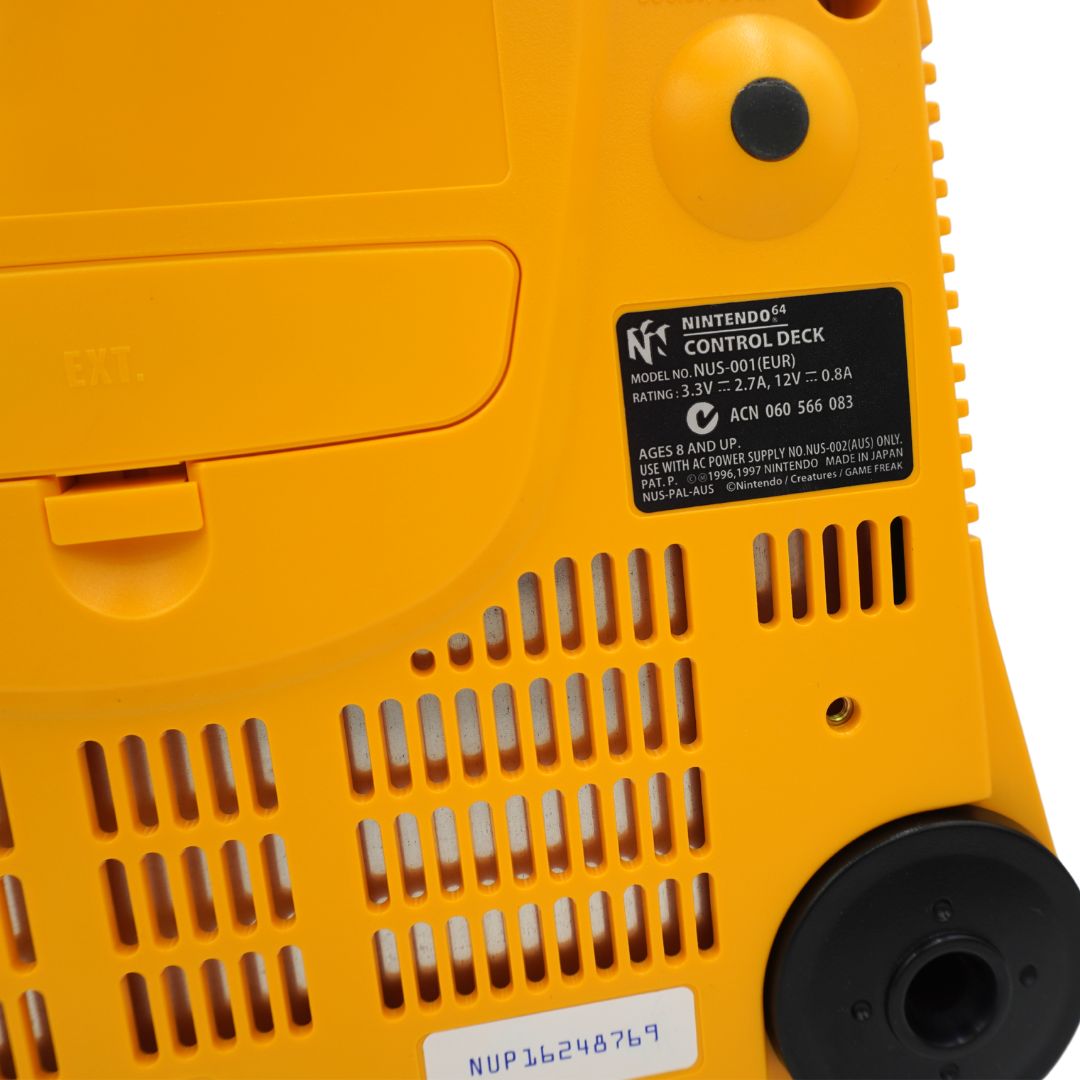 Close-up of the underside of a yellow Nintendo Control Deck game controller, showing the model label, vented plastic casing, and a black circular port.