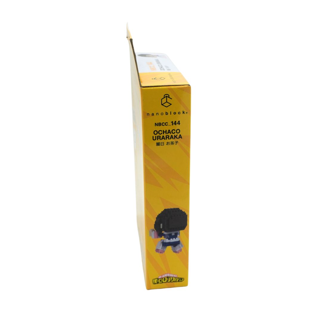 A tall, narrow yellow product box shown upright on a plain white background. The box has black text reading 'nanoblocks' and 'NBCC_144 OCHACO URARAKA', plus a small character illustration near the bottom.