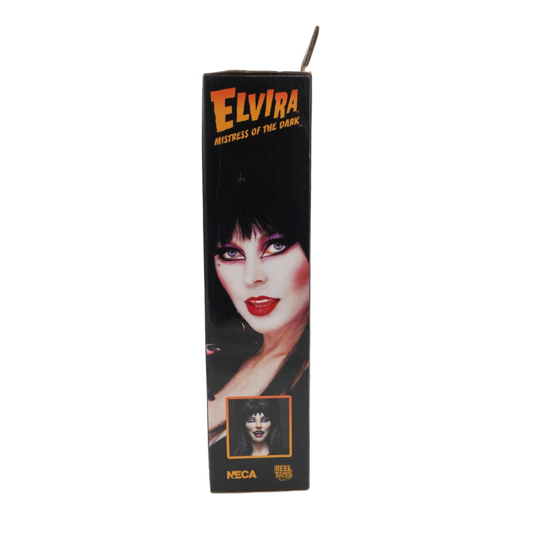A vintage NECA collectible figure of Elvira, Mistress of the Dance, shown in its original black packaging box against a plain white background.
