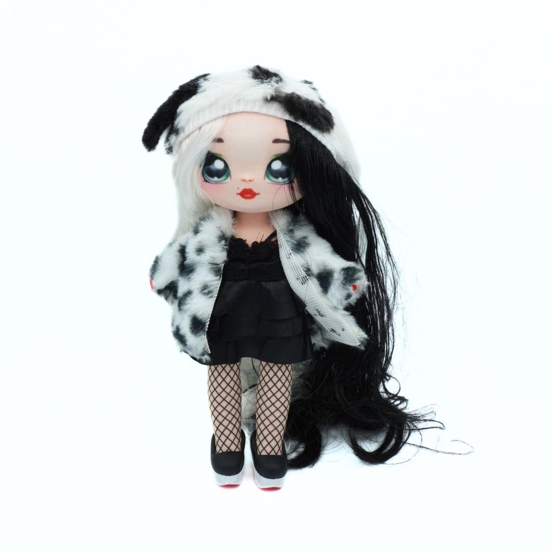 A doll with long black hair, wearing a black and white spotted faux fur coat, a black dress, fishnet tights, and black shoes, set against a plain white background.