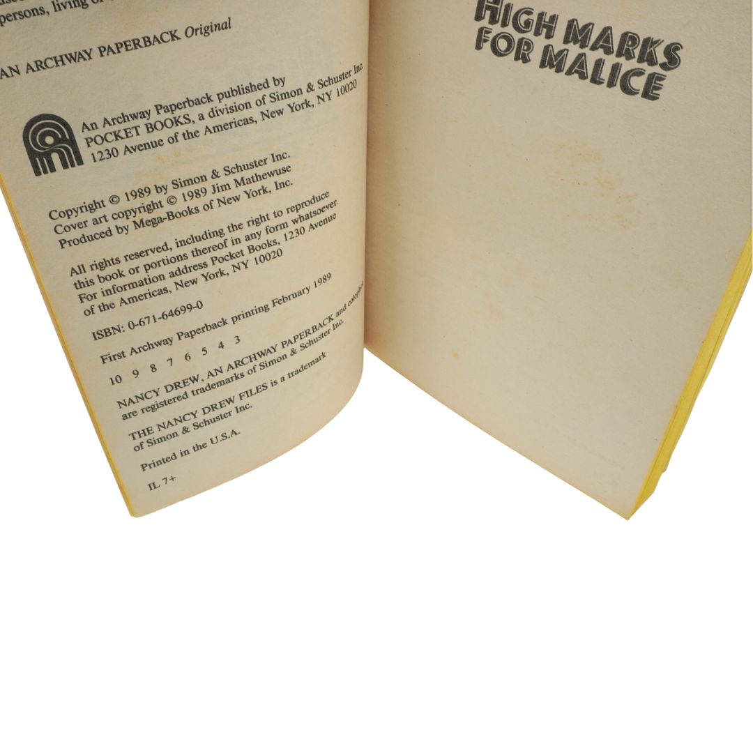 Open book showing copyright page and text 'High Marks for Malice'