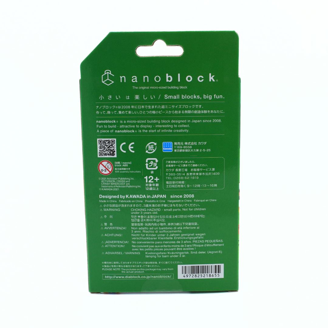 The back of a green Nanoblock toy packaging card, featuring product information, safety certifications, and a barcode on a white background.