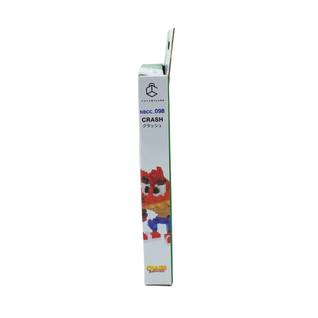 A tall, narrow product box shown upright against a plain white background. The box is mostly white with blue text reading 'NBCC 058 CRASH' and a colorful pixel-art character illustration near the bottom.