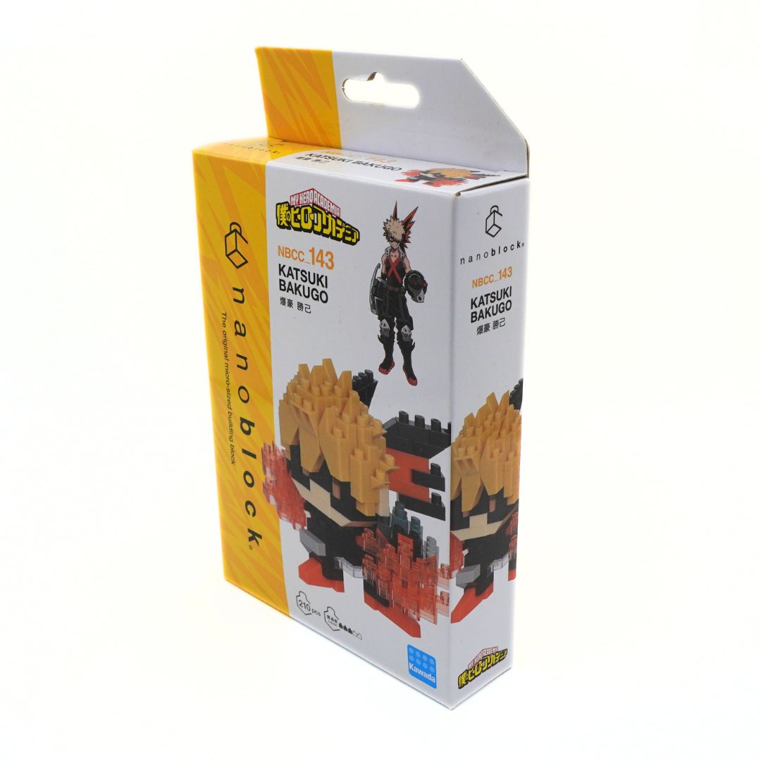 A boxed set of small building blocks branded Nanoblock, featuring an anime character figure on the front and side packaging. The box is primarily white with a yellow side panel and printed product photos, photographed on a plain white background.