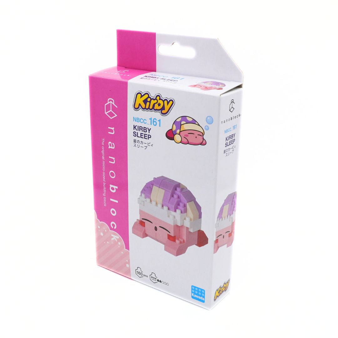 Kirby Sleep nanoblocks toy box, model NBCC_161, featuring a pink and white packaging design with an illustration of the character Kirby inside a purple shell.