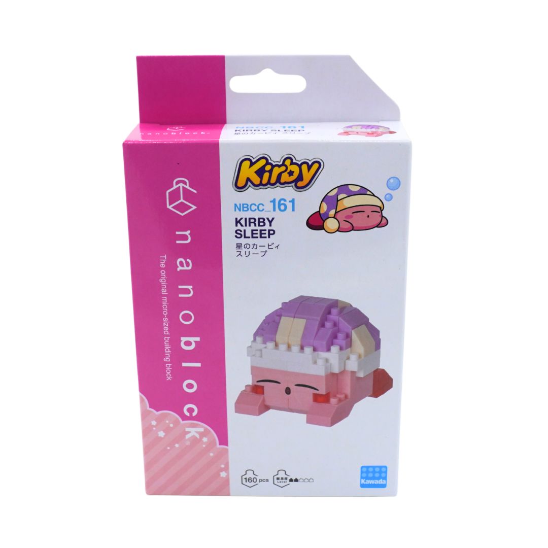 A boxed Kirby 'Kirby Sleep' nanoblock toy package on a plain white background. The retail box is mostly white with bright pink panels and printed character art of Kirby sleeping under a purple and cream blanket.