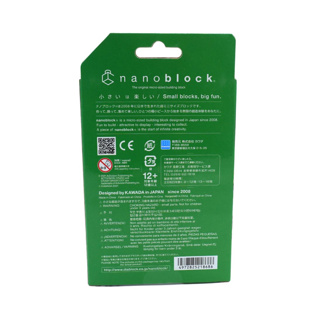 The back of a green Nanoblock retail packaging card, featuring product information, regulatory compliance logos, and a barcode on a plain white background.