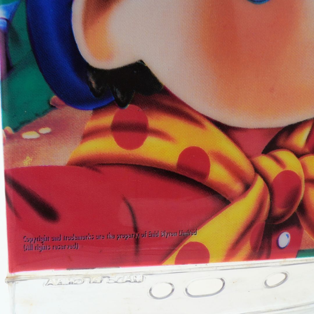 Close-up of a character with a yellow scarf with red polka dots, wearing a red outfit.