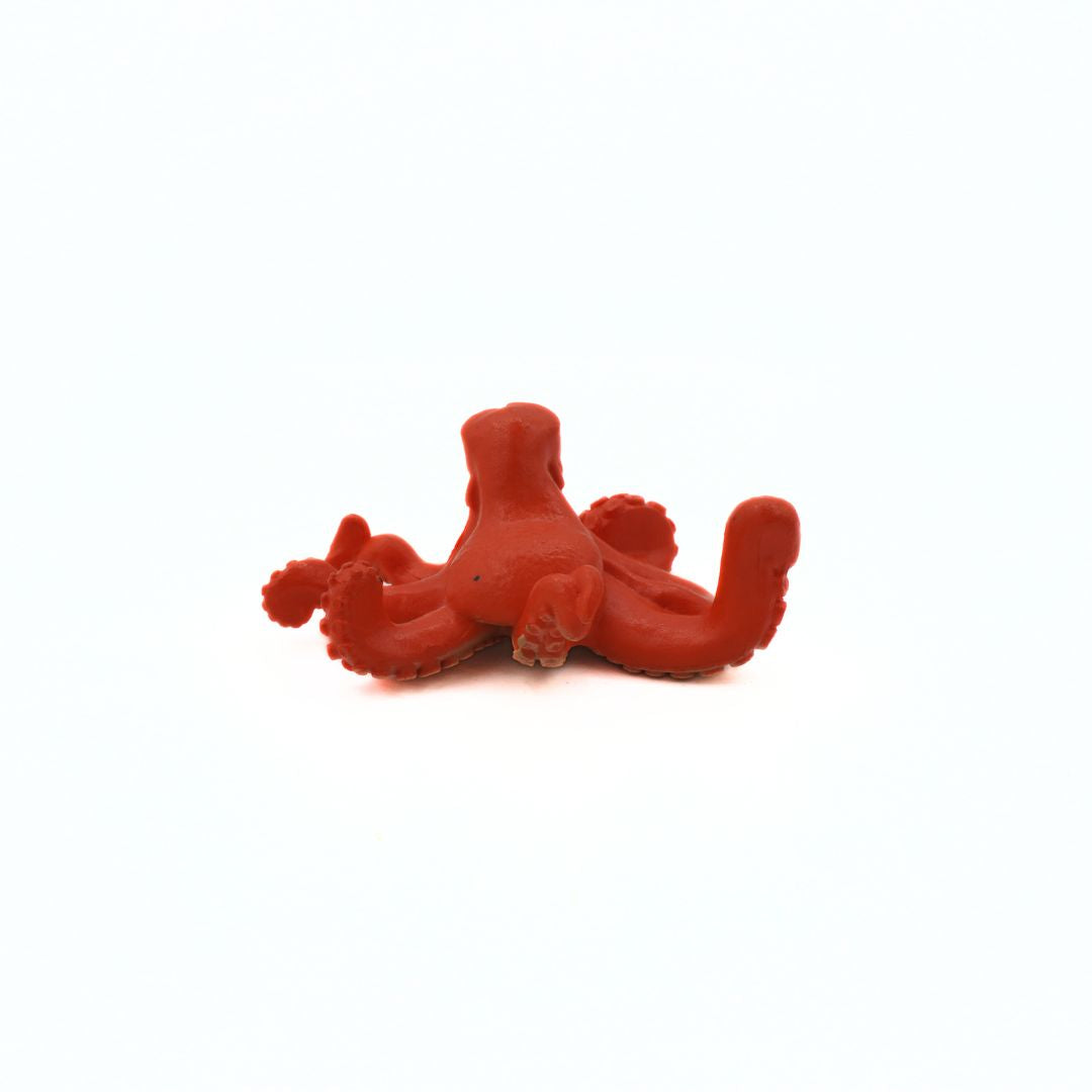 Red octopus toy on a white background