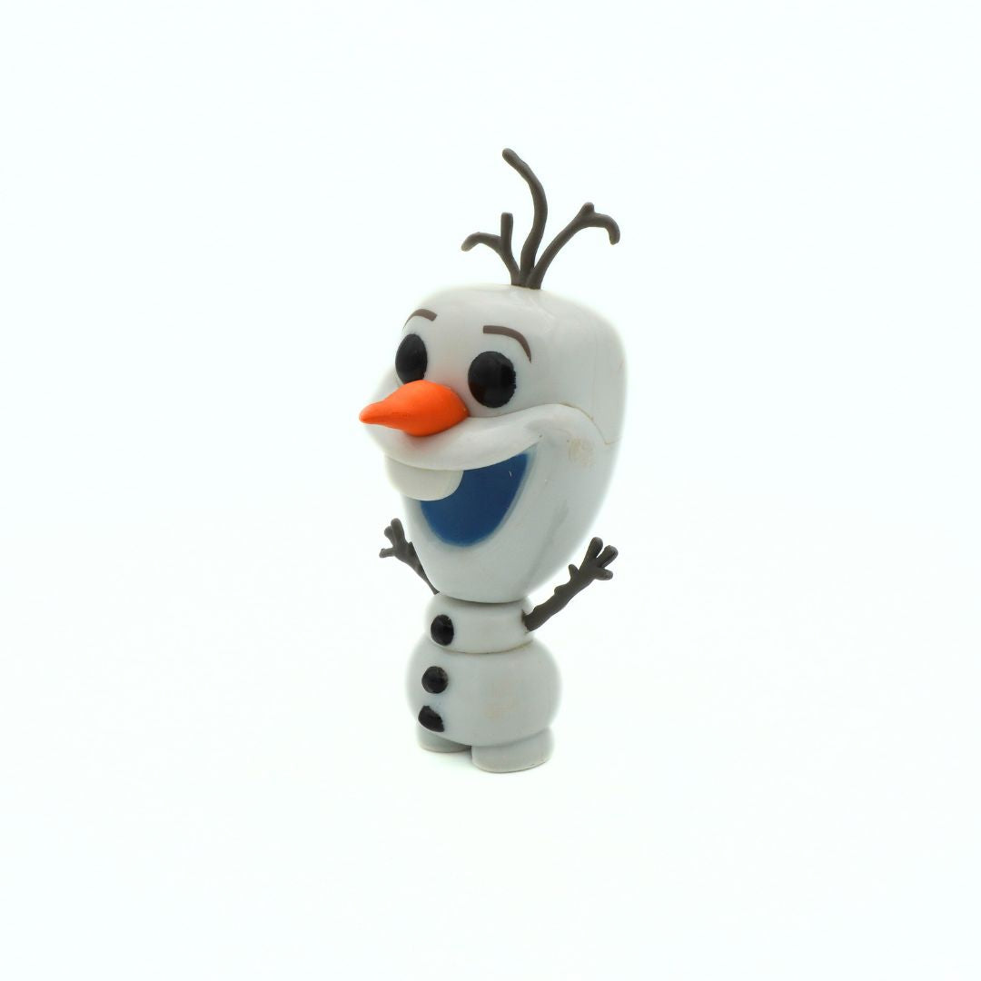 Toy figure of a snowman with a carrot nose and black buttons on a white background