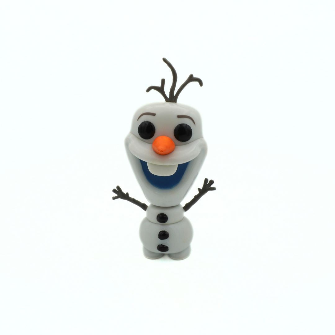 Toy figure of a snowman with a carrot nose on a white background