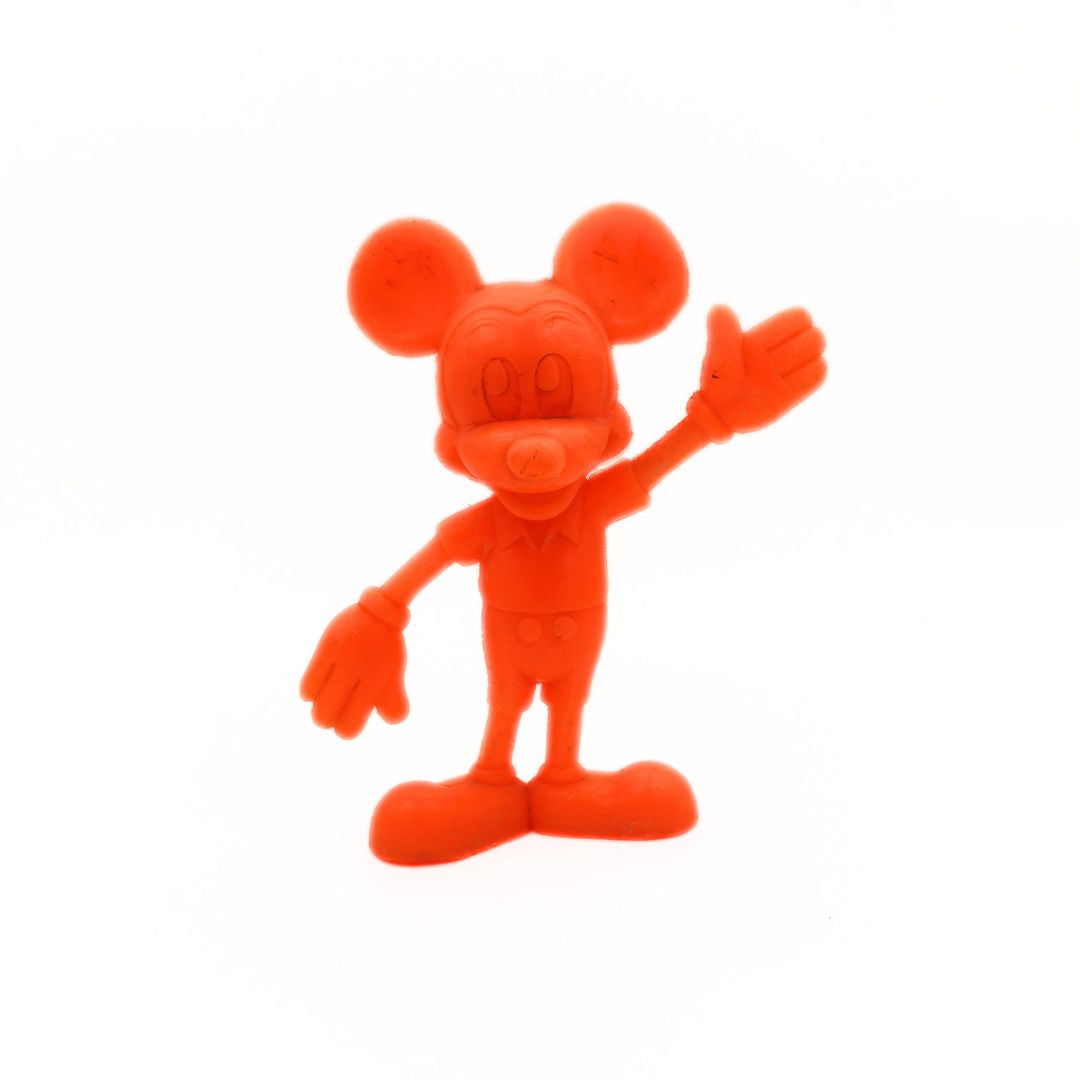 Red cartoon character figurine on a white background