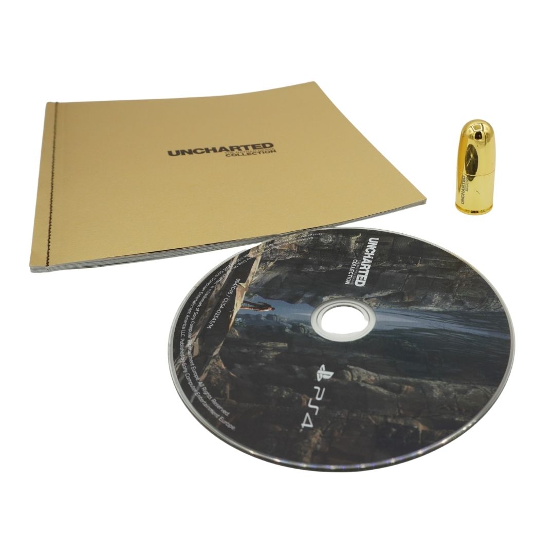 Uncharted Collection game package for PlayStation 4, including a gold booklet, a PS4 game disc with Uncharted artwork, and a gold capsule-shaped accessory on a white background.