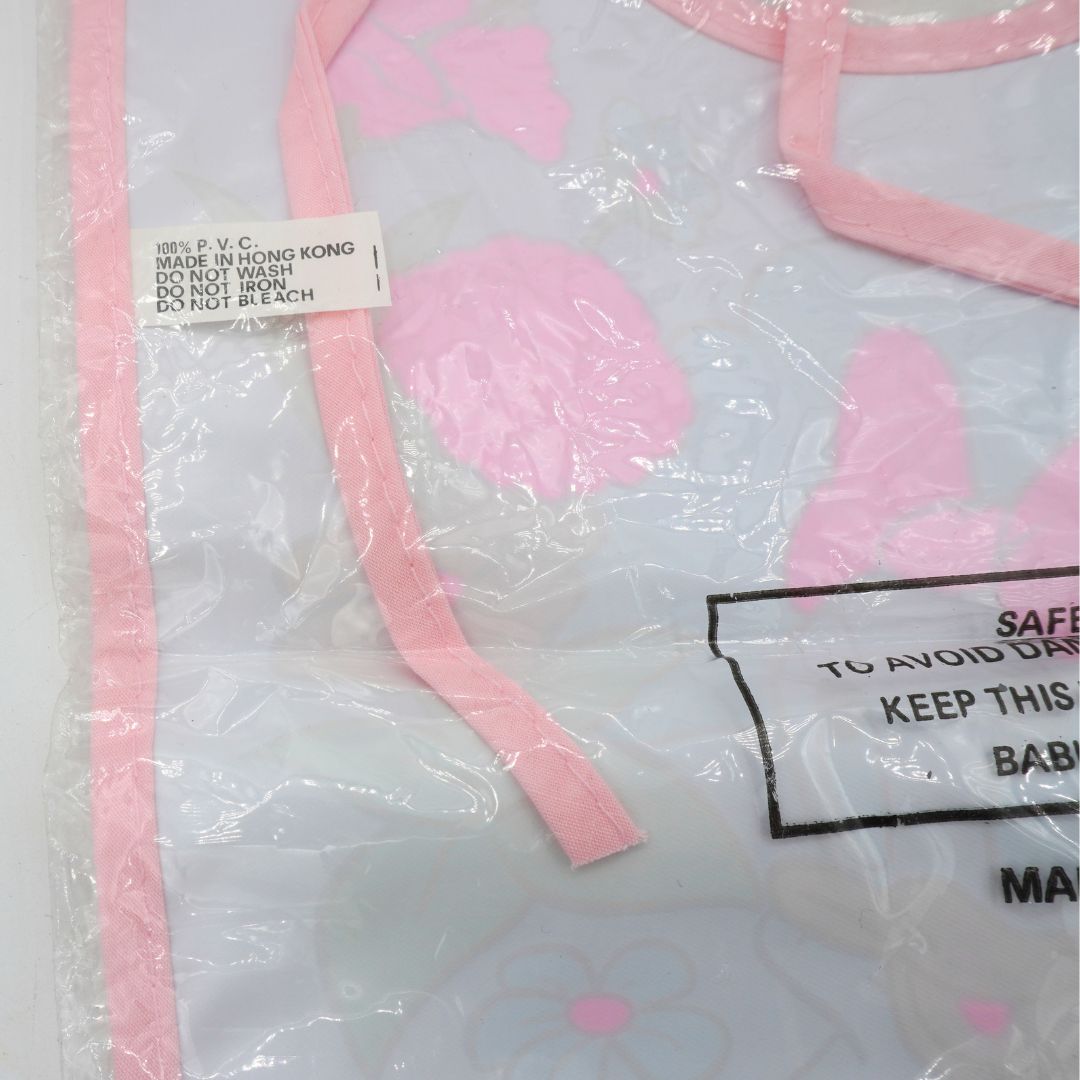 Pink and white bib with care label on a white background