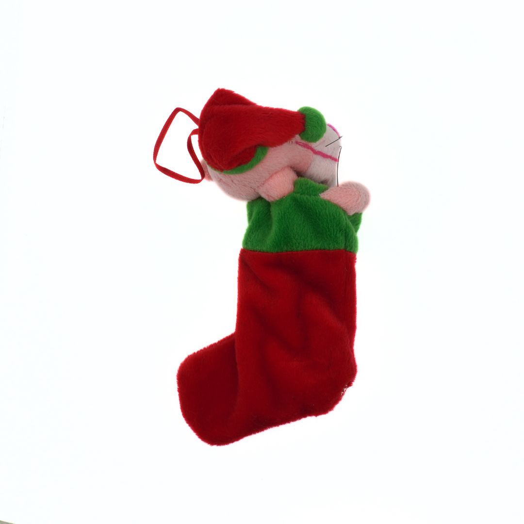Red Christmas stocking with a small figure inside on a white background