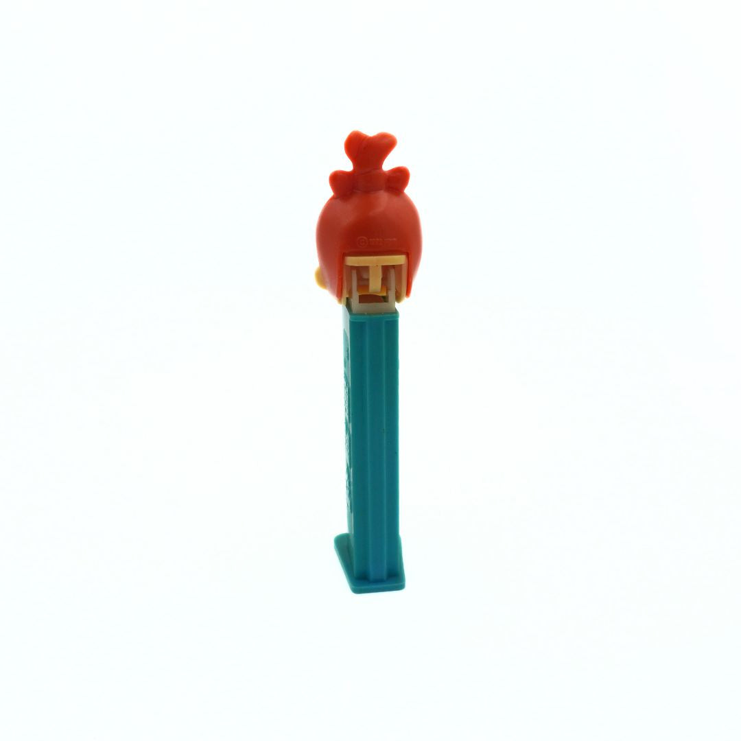 A vintage Pez dispenser of Pebbles from the Flinstones, with a green body