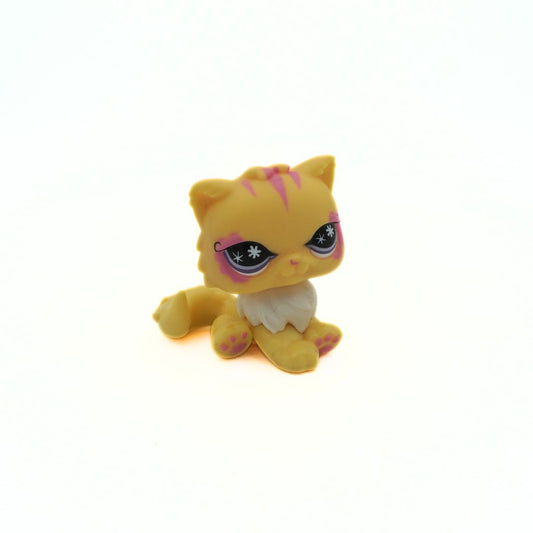 Small yellow plastic toy with cat-like features on a white background