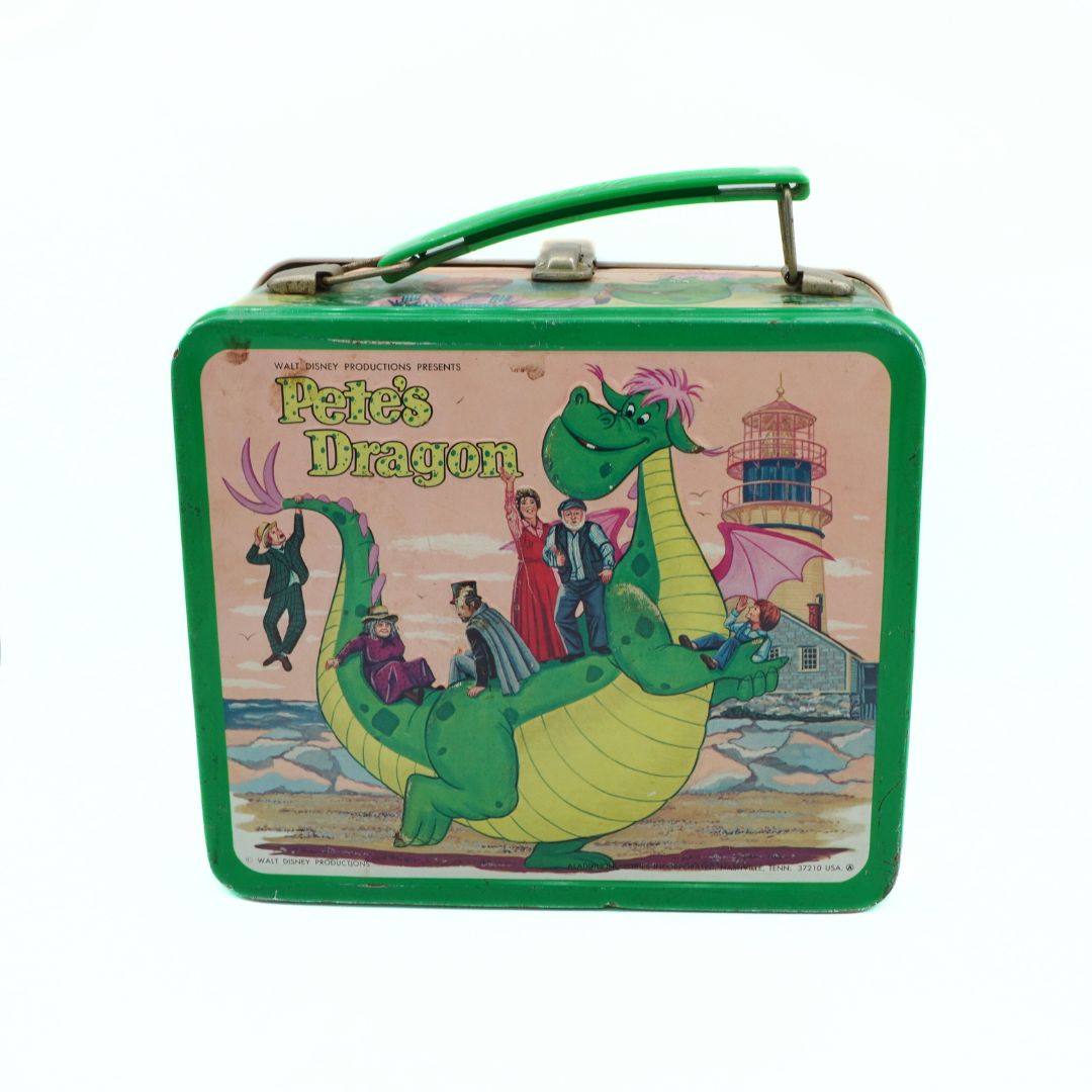 Vintage 'Pete's Dragon' lunch box with green dragon illustration on a white background