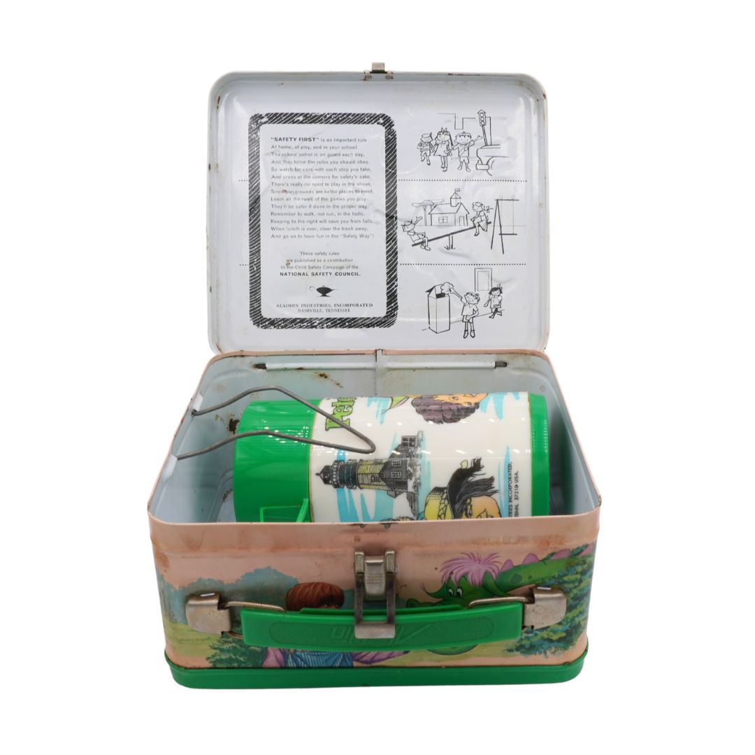 Open vintage-style lunch box with green and white design on a white background