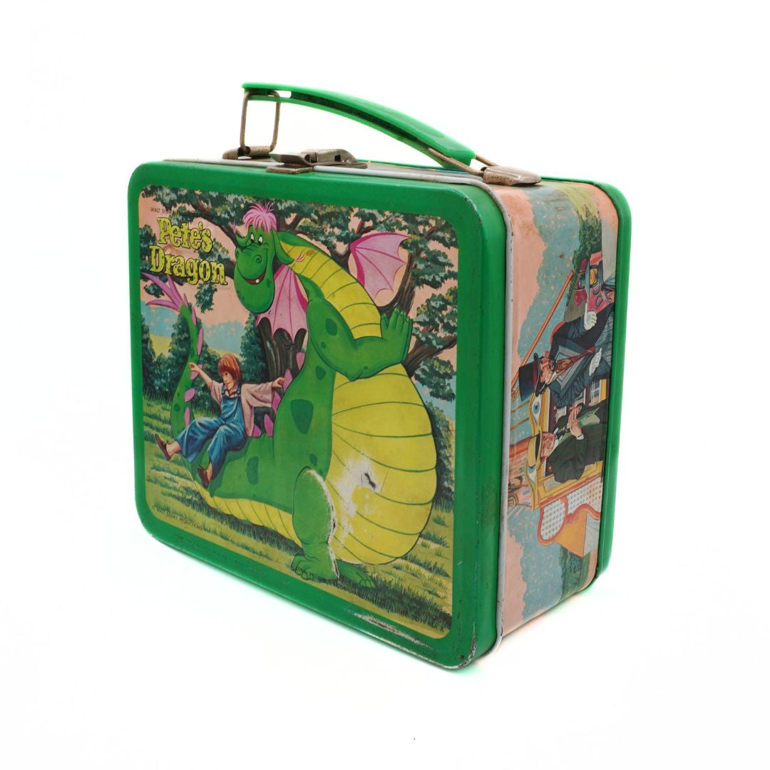 Vintage lunch box with 'Peter's Dragon' design on a white background