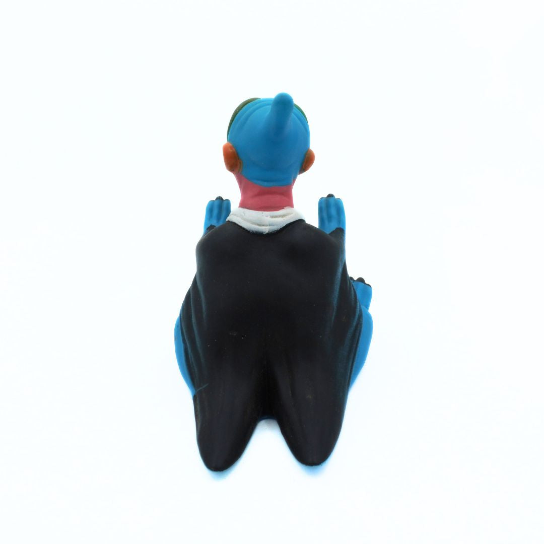 Toy figure of a character with a blue head and black wings on a white background