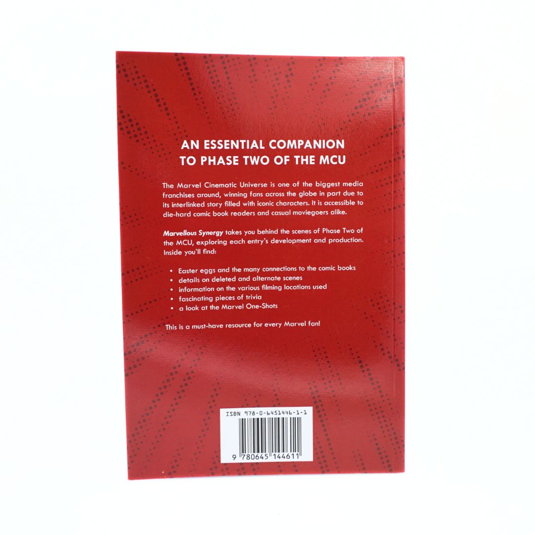 The back cover of a red book, photographed against a plain white background. The cover features white text describing the book's content about Marvelous Synergy and the MCU, with a barcode at the bottom.