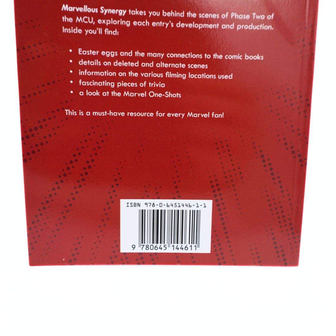 The back cover of a red book or box, featuring white descriptive text, a bulleted list, and a barcode near the bottom.