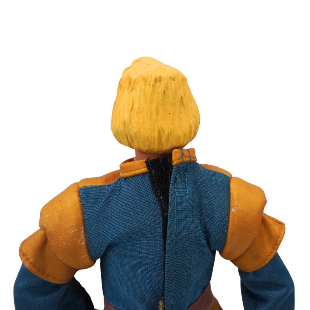 Action figure with yellow hair and blue and orange outfit on a white background