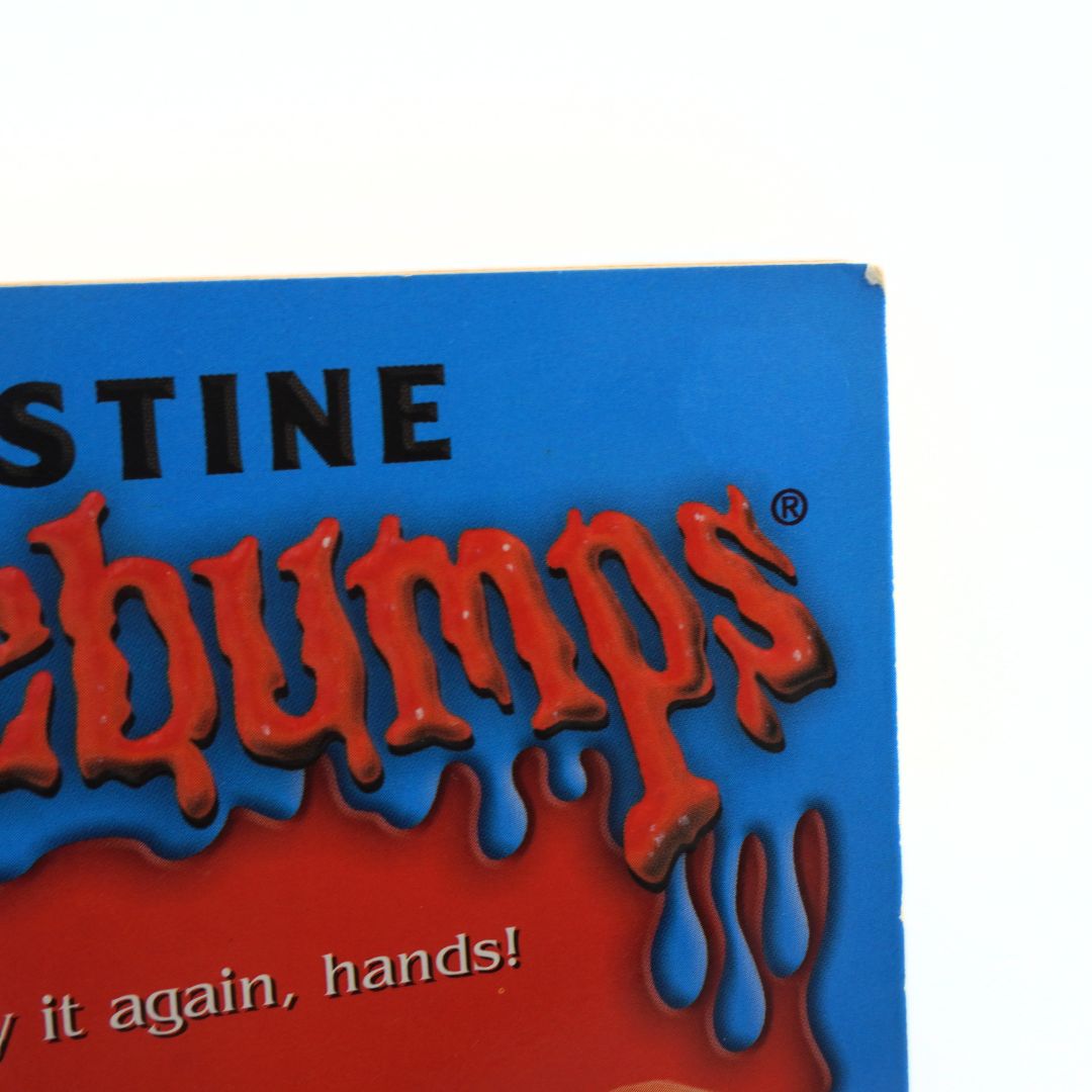 A corner of a vintage Goosebumps book showing light wear and damage