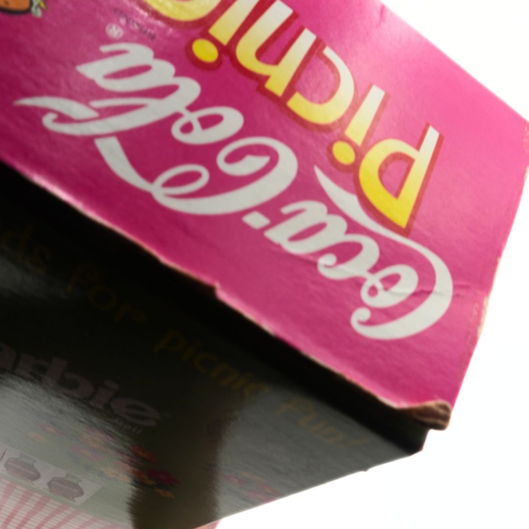 Close-up of a pink box holding the Coca-Cola Picnic Barbie