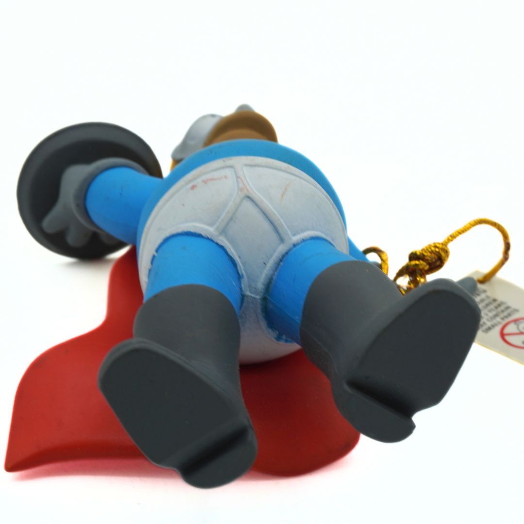 Underside of a Homer Simpson Pie Man figure with a blue, white and red costume and black boots