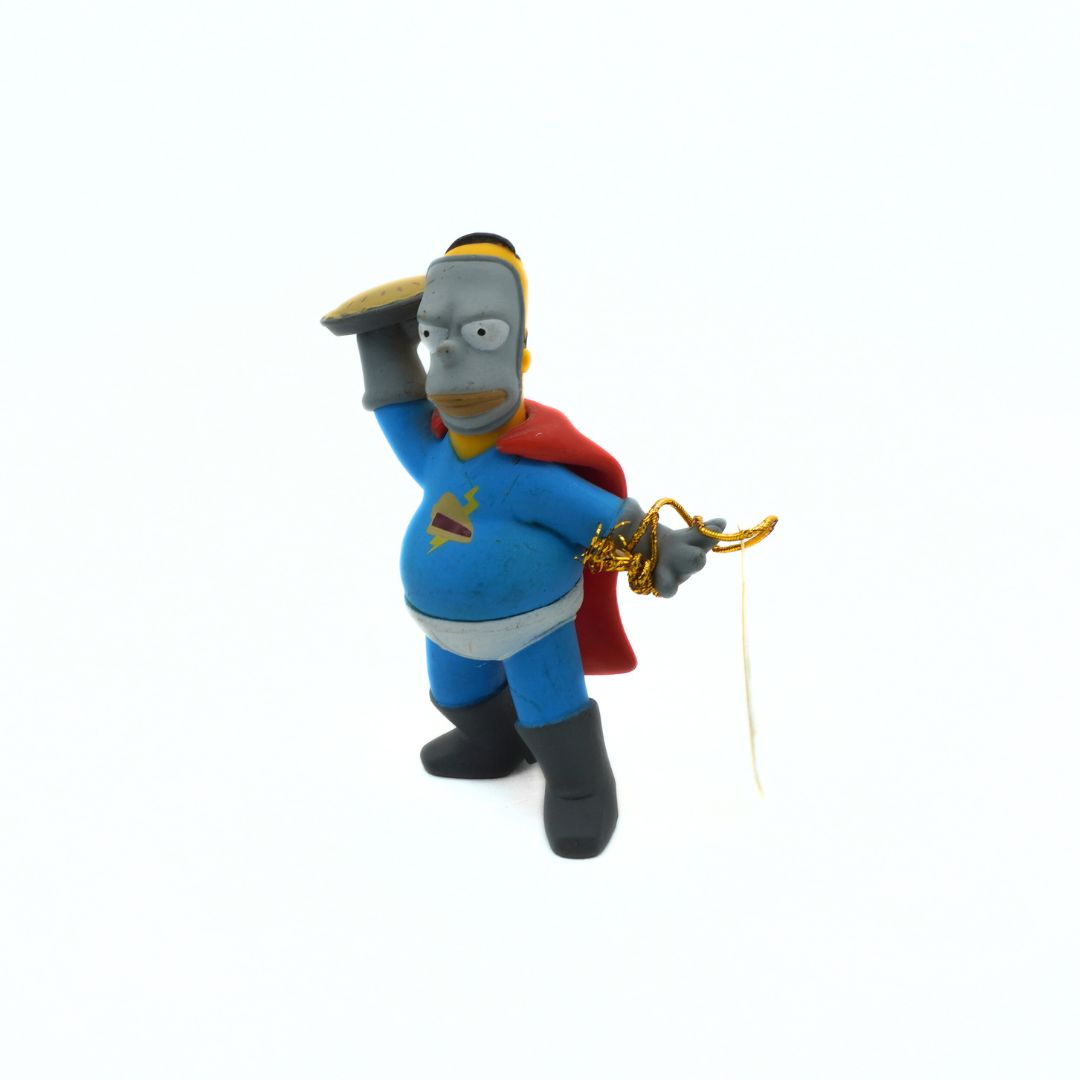Superhero figurine with cape and helmet on a white background