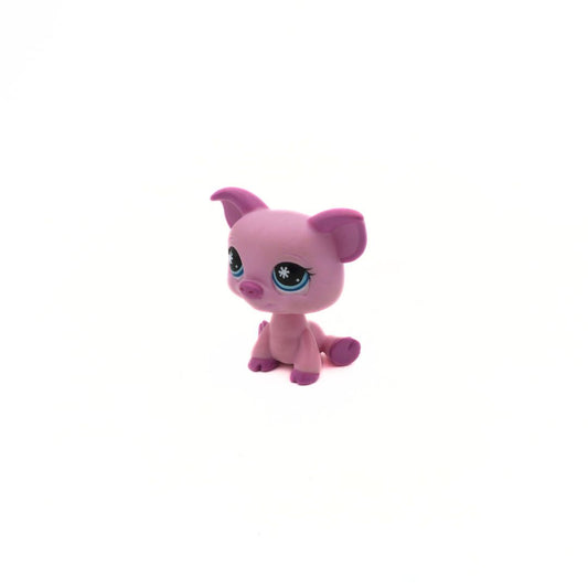 Small pink toy figure with purple accents on a white background