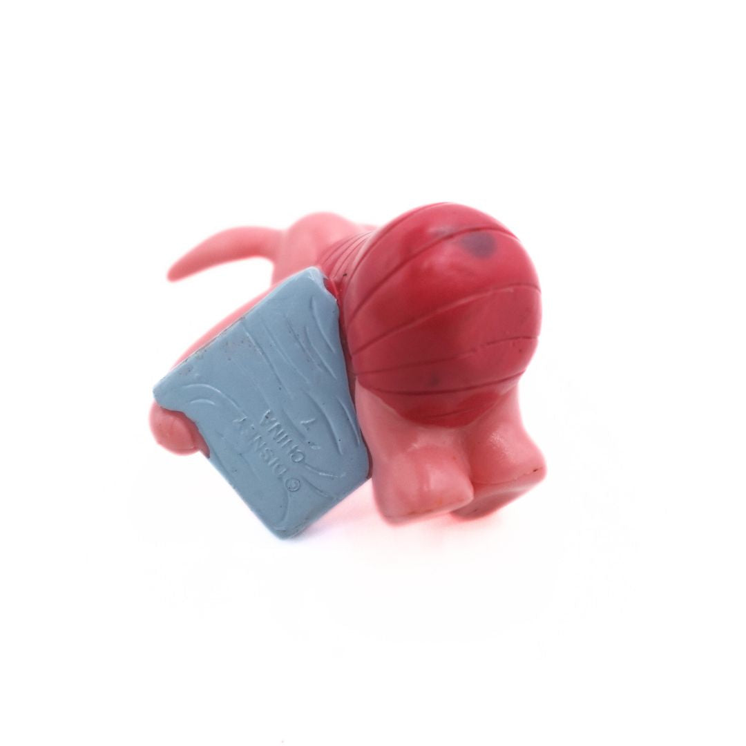 Underside of a Disney Piglet figurine showing the branding and some wear