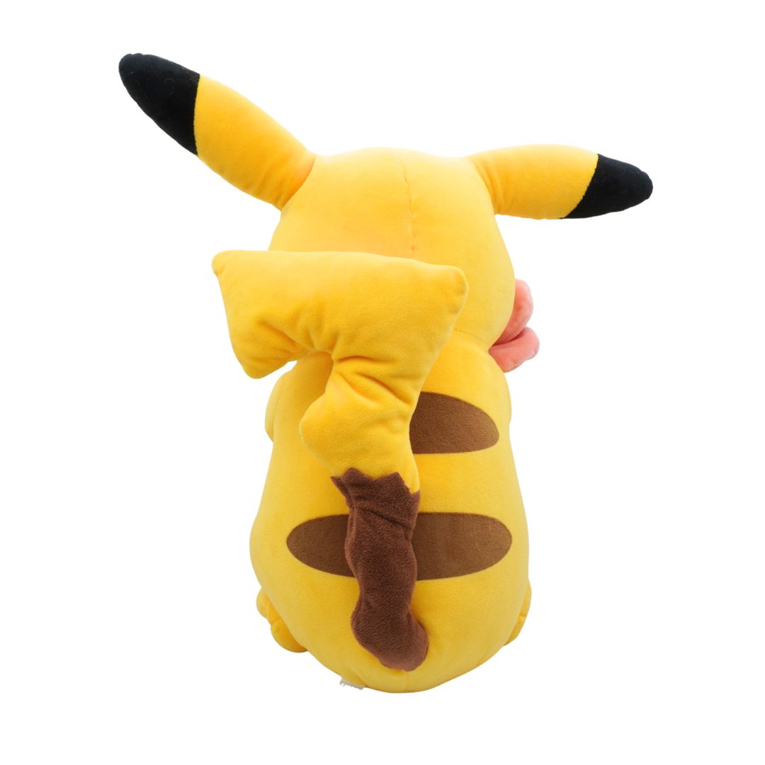 Plush toy shaped like a yellow creature with black ears and brown spots on a white background