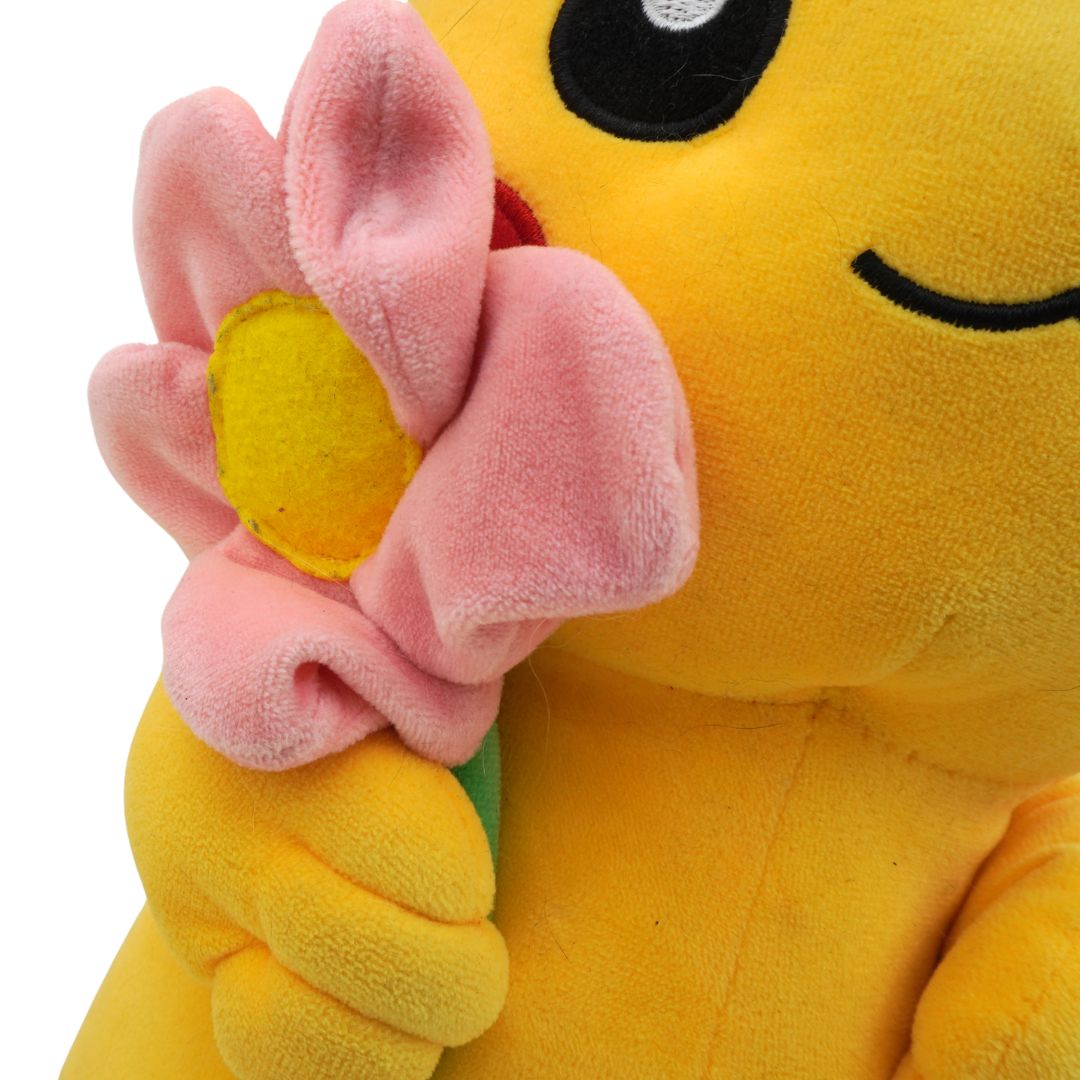 Yellow plush toy holding a pink flower with a white background