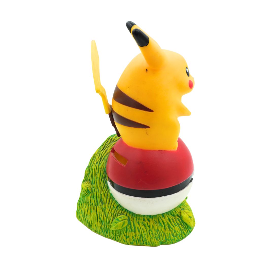 Toy figure of a character with a red base and grass-like texture on a white background