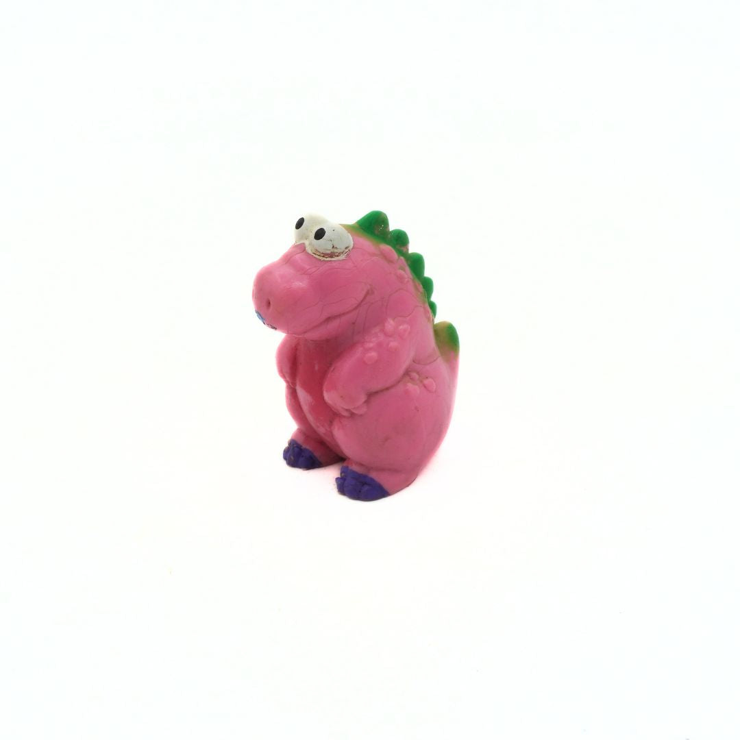 Pink dinosaur plastic toy on a white background