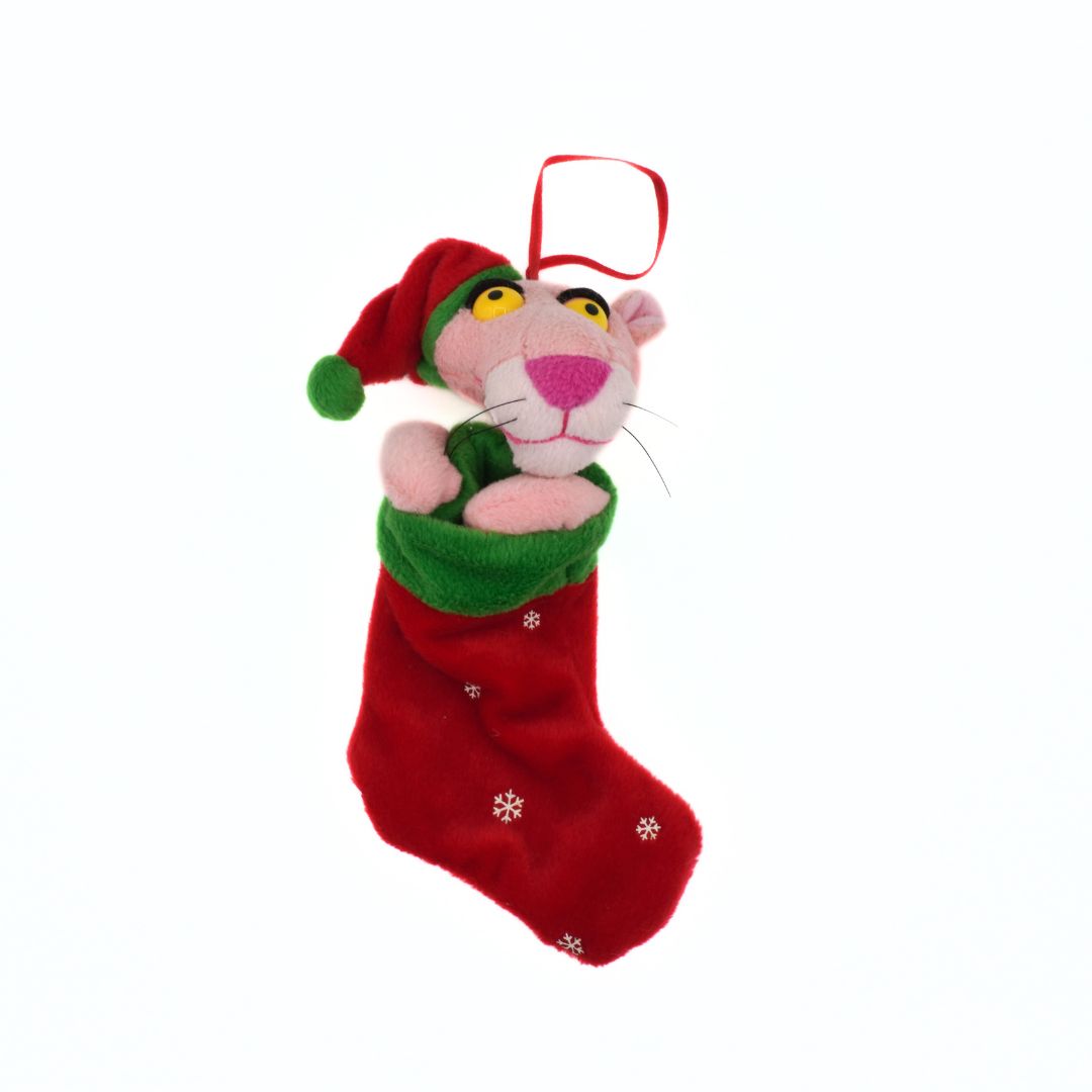 Plush toy resembling a pink panther in a red Christmas stocking on a white background