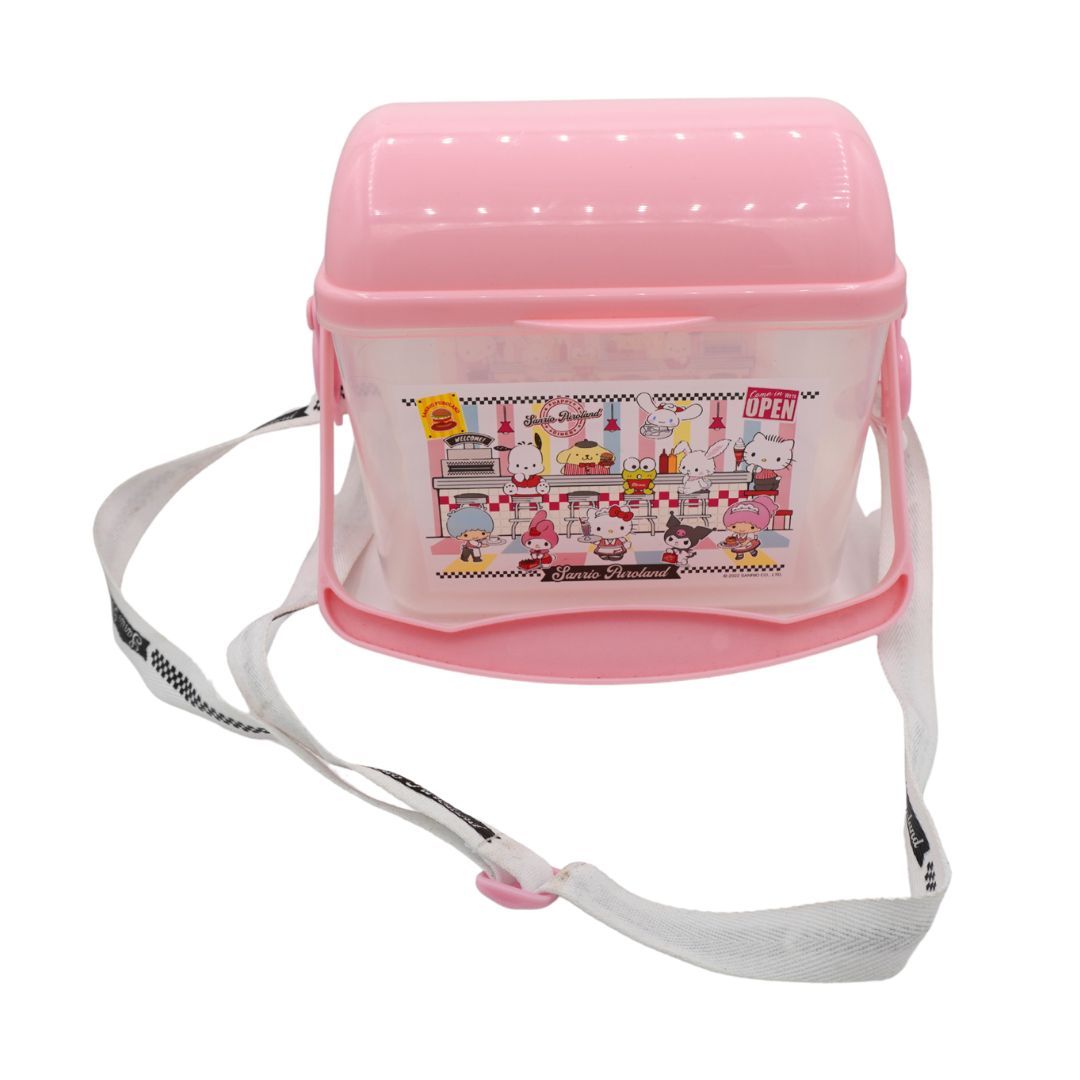A pink and clear plastic lunch bag with a white shoulder strap, featuring a colorful cartoon illustration of Hello Kitty on the front.