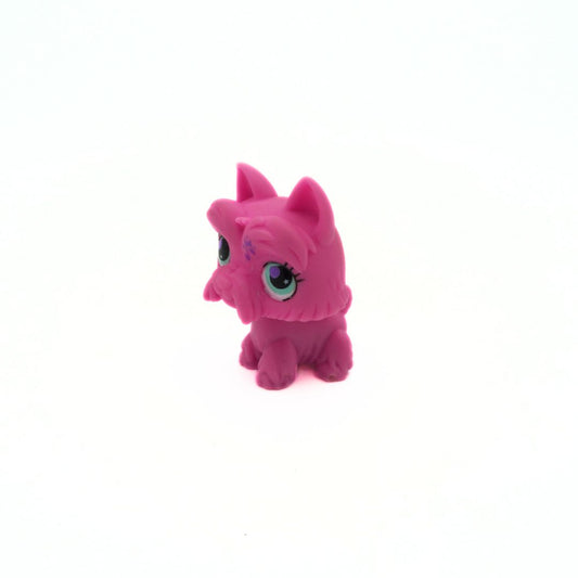 Pink toy figure with large eyes on a white background