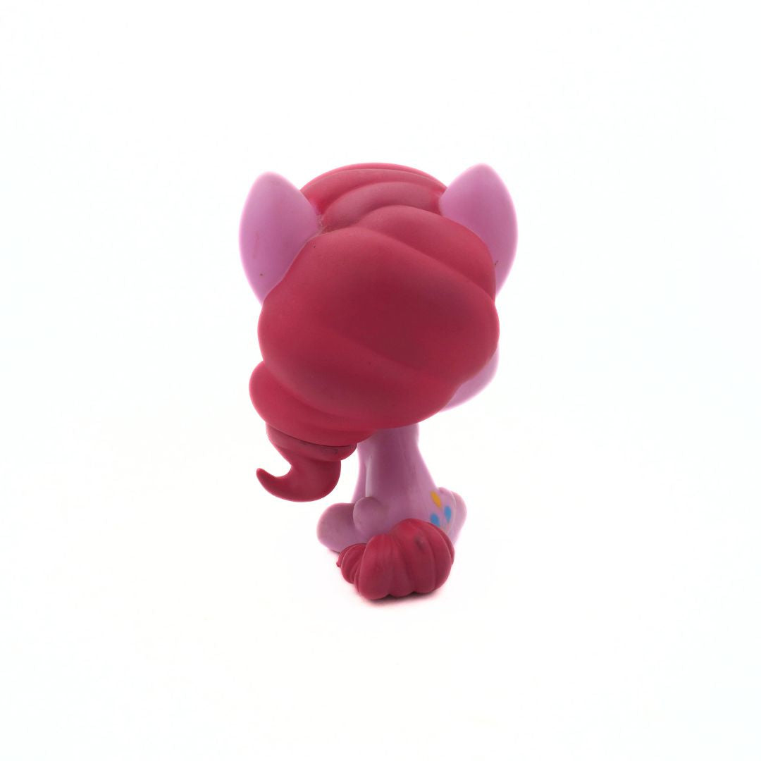 Toy figure with pink and red color scheme on a white background
