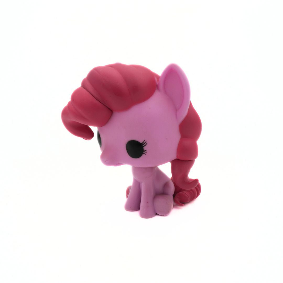 Pink toy pony with red hair on a white background