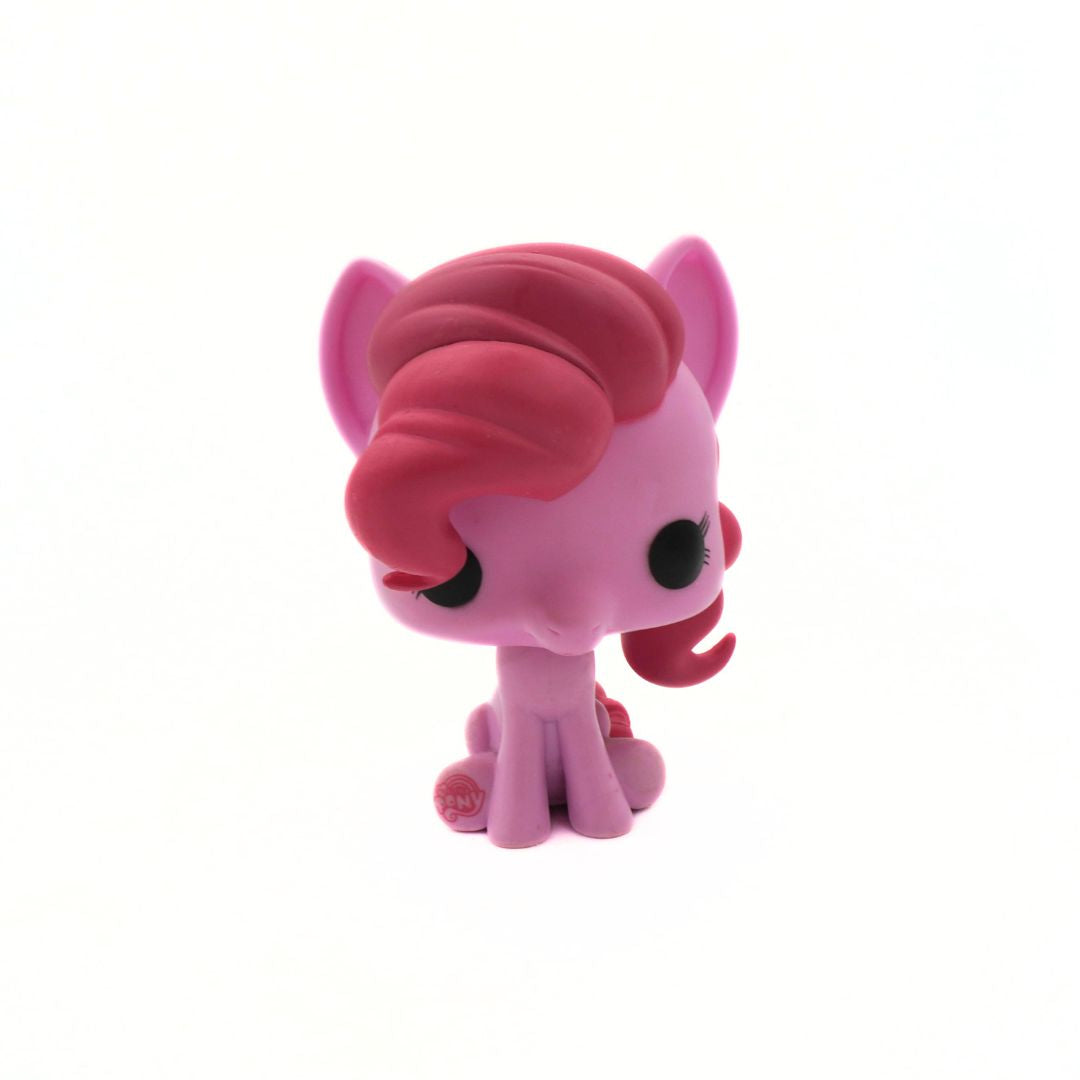 Pink toy pony with a curly mane on a white background